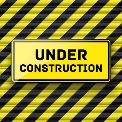 Under,Construction,Sign,Hanging,On,Striped,Door,Shutter