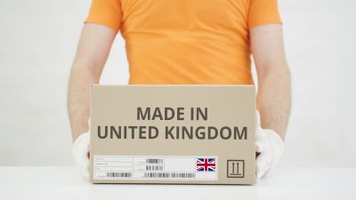 Man,Puts,Cardboard,Box,With,Made,In,United,Kingdom,Text