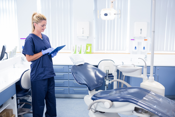 Dentist Working On Tablet Pc